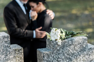 Grieving woman crying at the tombstone