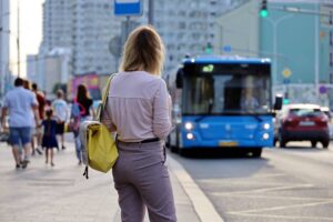 Lady commuter waiting for her bus to arrive.