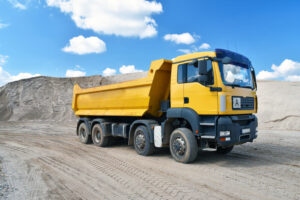 Yellow dump truck in an open pit mine.