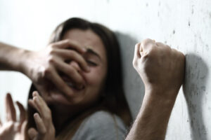 Sexual abuse with a man attacking to a scared woman in a dark place.