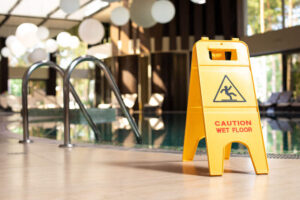 Caution warning sign in swimming pool area.