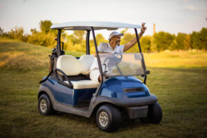 Senior man riding the golf cart.