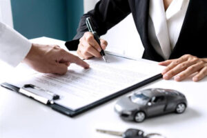 Client signing car insurance documents.