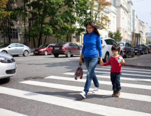Mother and child crossing the street.
