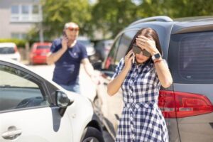 Lady driver worried on the car collision.