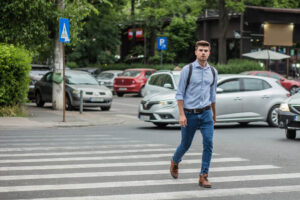 Man crossing the pedestrian lane.